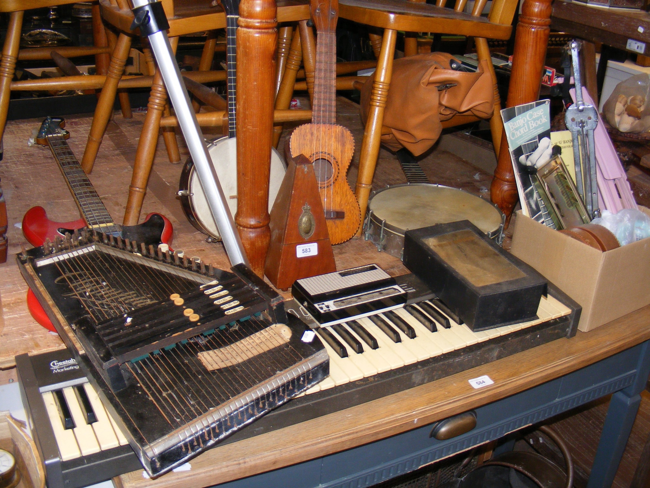 A collection of play worn musical instruments, including electric bass ...