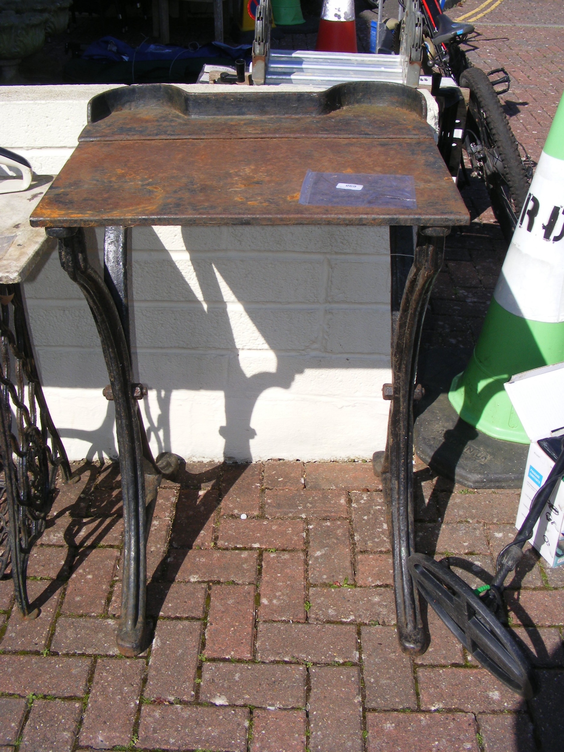 An antique cast metal printer's table