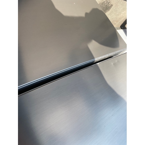 357 - Working Grundig Stainless Fridge Freezer - some cosmetic damage as shown 
61cm x 60cm x 183cm 
Water... 