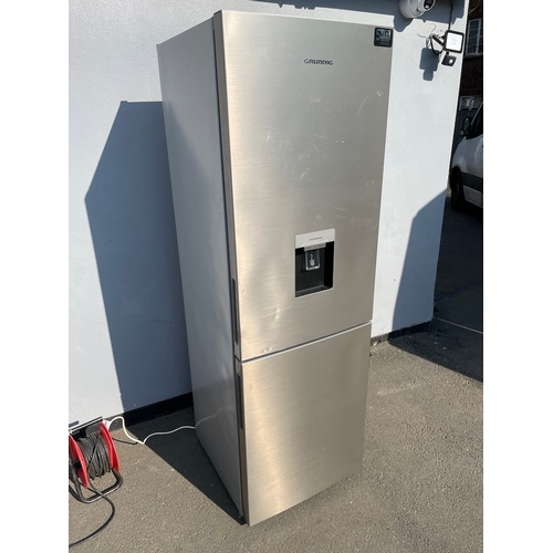 357 - Working Grundig Stainless Fridge Freezer - some cosmetic damage as shown 
61cm x 60cm x 183cm 
Water... 