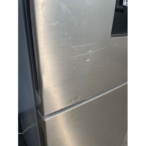 357 - Working Grundig Stainless Fridge Freezer - some cosmetic damage as shown 
61cm x 60cm x 183cm 
Water... 