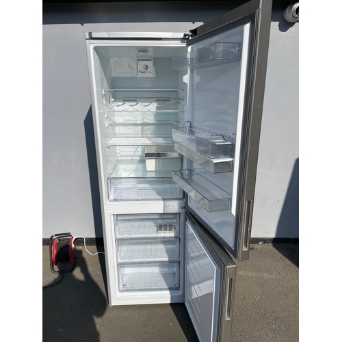 357 - Working Grundig Stainless Fridge Freezer - some cosmetic damage as shown 
61cm x 60cm x 183cm 
Water... 