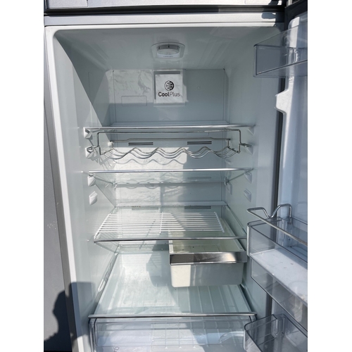 357 - Working Grundig Stainless Fridge Freezer - some cosmetic damage as shown 
61cm x 60cm x 183cm 
Water... 