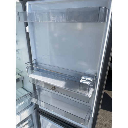 357 - Working Grundig Stainless Fridge Freezer - some cosmetic damage as shown 
61cm x 60cm x 183cm 
Water... 