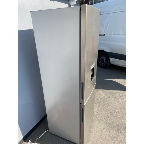 357 - Working Grundig Stainless Fridge Freezer - some cosmetic damage as shown 
61cm x 60cm x 183cm 
Water... 