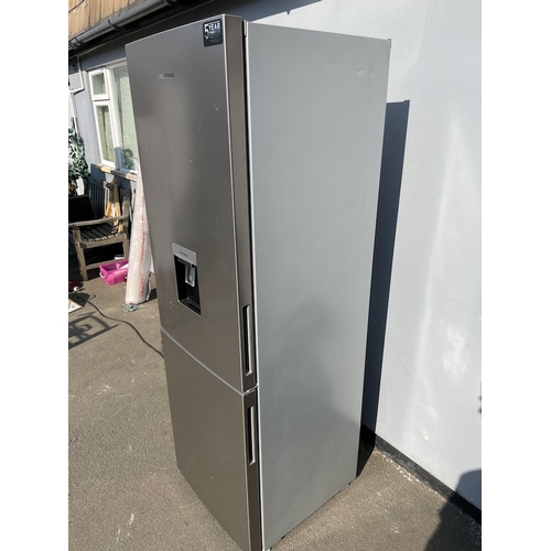 357 - Working Grundig Stainless Fridge Freezer - some cosmetic damage as shown 
61cm x 60cm x 183cm 
Water... 