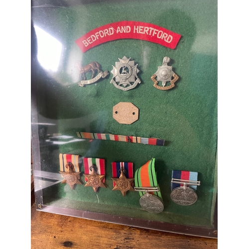 193 - Framed Collection of Five WW2 Military Medals inc Bedford & Hertford, The Queens, Royal Sussex Regim... 