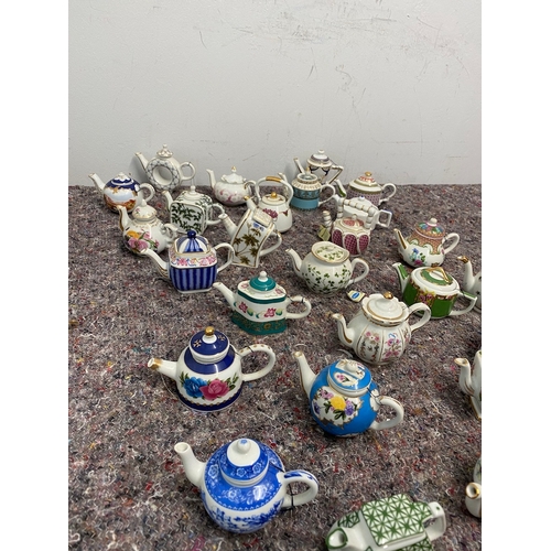 107 - Collection of 27 Porcelain Art Miniature Tea pots with tags all in very good order