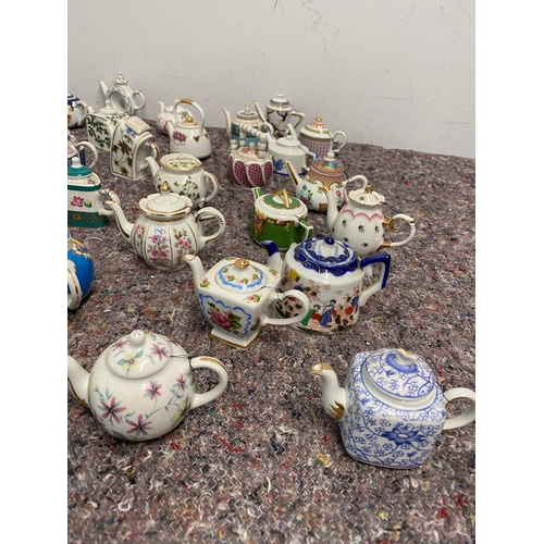 107 - Collection of 27 Porcelain Art Miniature Tea pots with tags all in very good order