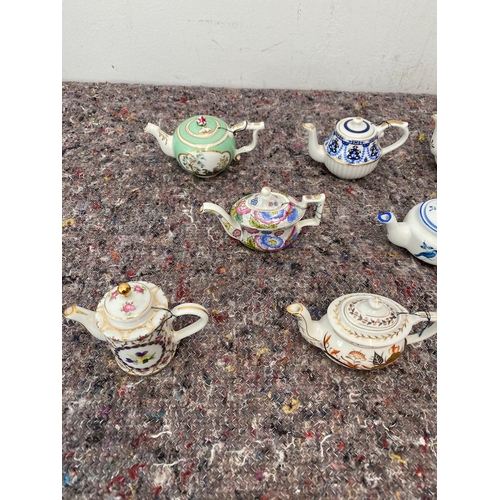 98 - Collection of 11 Porcelain Art Miniature Tea pots with tags all in very good order