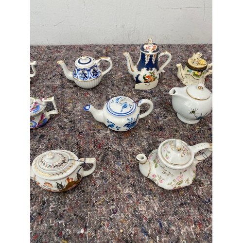 98 - Collection of 11 Porcelain Art Miniature Tea pots with tags all in very good order