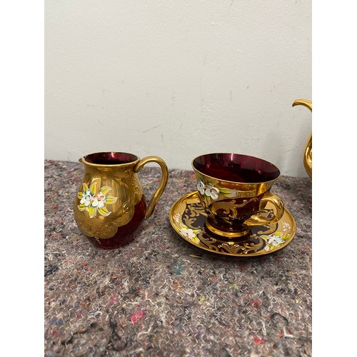 166 - Vintage cranberry and gilded glassware tea set - damage to lid on tea pot