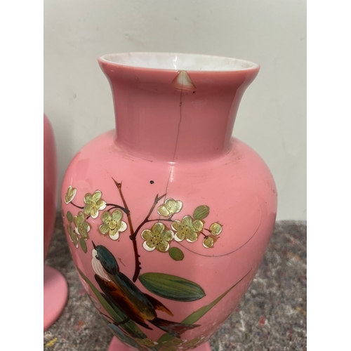 5 - Two 20th century pink opaque glass urns with handprinted decoration 31CM - A/F