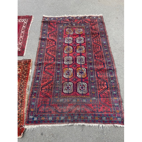 152 - Three vintage red rugs / carpets