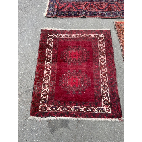 152 - Three vintage red rugs / carpets