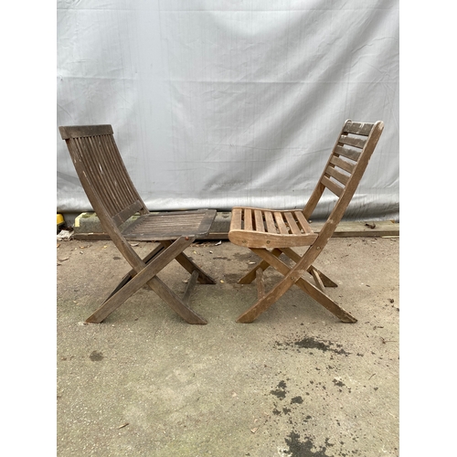 479 - Two teak garden chairs.