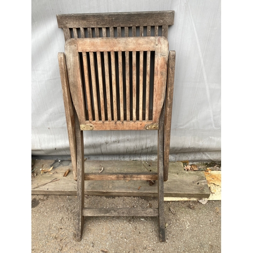 479 - Two teak garden chairs.