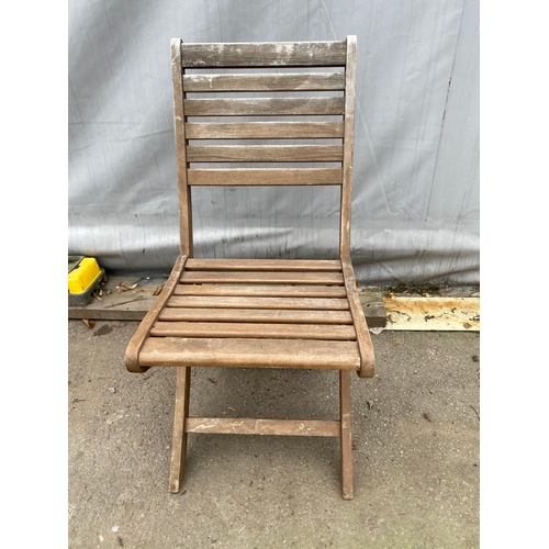 479 - Two teak garden chairs.