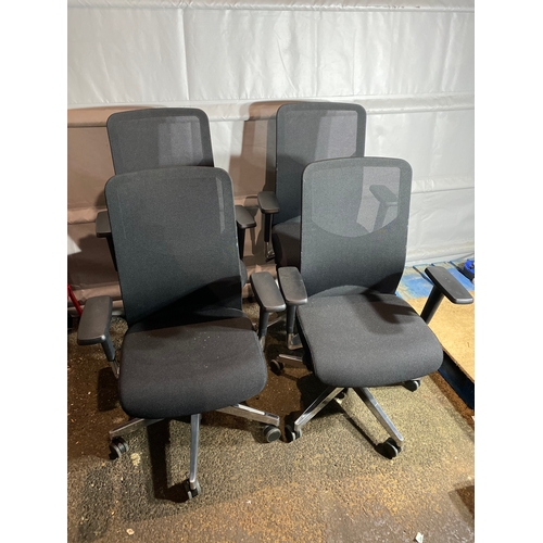 302 - Set of four black adjustable office chairs.