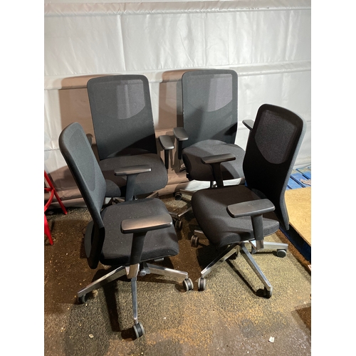 302 - Set of four black adjustable office chairs.