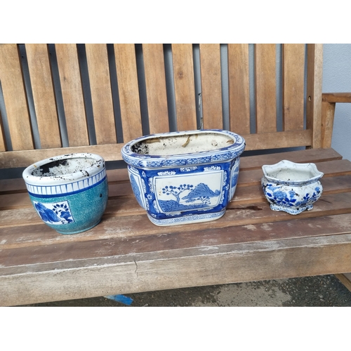 376 - Three oriental themed decorative blue and white flower pots.