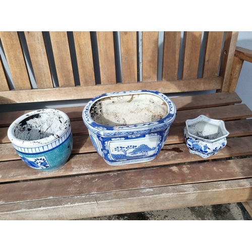 376 - Three oriental themed decorative blue and white flower pots.