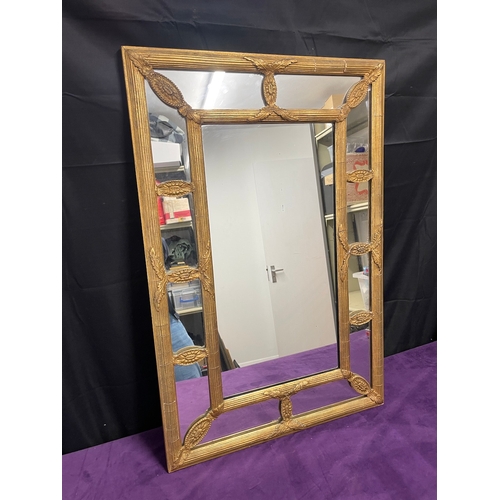 51 - A Regency Gilt Cushion Wall Mirror, plated rectangle centred panel separated by reeded and floral mo... 