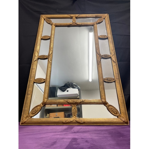 51 - A Regency Gilt Cushion Wall Mirror, plated rectangle centred panel separated by reeded and floral mo... 