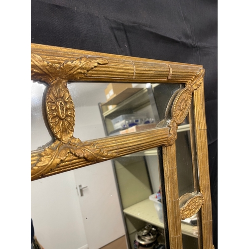 51 - A Regency Gilt Cushion Wall Mirror, plated rectangle centred panel separated by reeded and floral mo... 