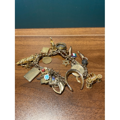 192 - Vintage 9ct yellow gold charm bracelet 
majority 9ct hallmarked  9 charms are plated / unmarked  - t... 