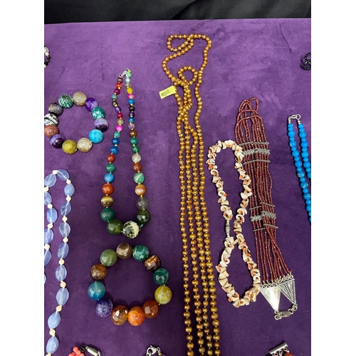 89 - Quantity of various coloured necklaces / some glass beads / pearls some with 375 stamped gold clasps