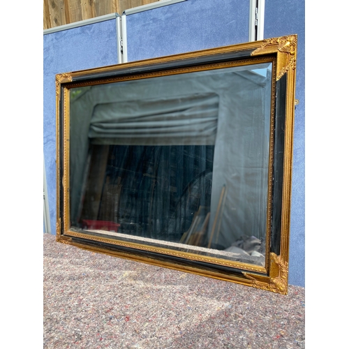 308 - Large Vintage gilt on black framed rectangular mirror

Dimensions - 46