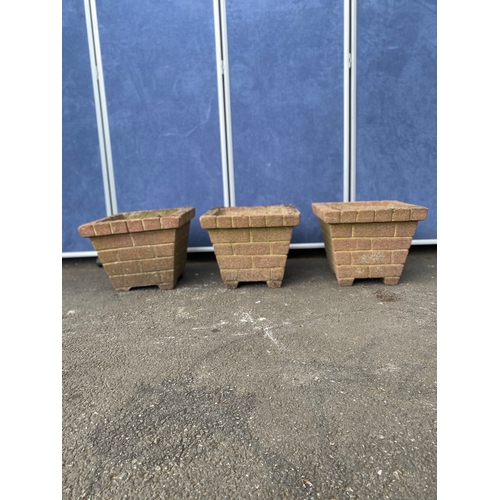 394 - A trio of matching brick design plant pots