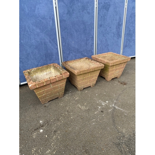 394 - A trio of matching brick design plant pots