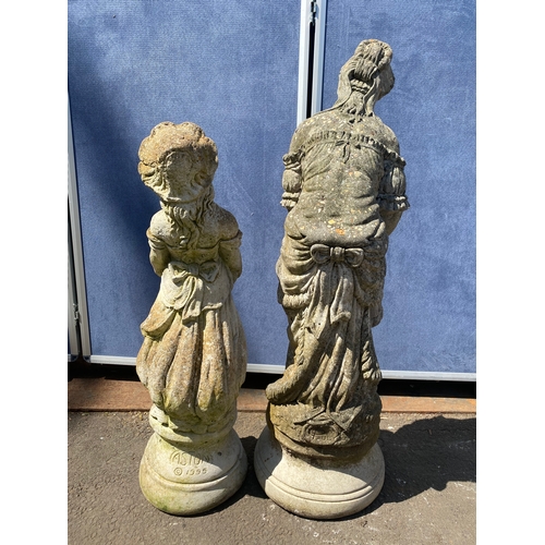 404 - A pair of stone statues depicting young girls holding dogs and a bird