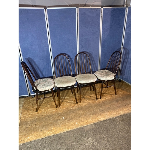 194 - A set of four ebonised stick back chairs