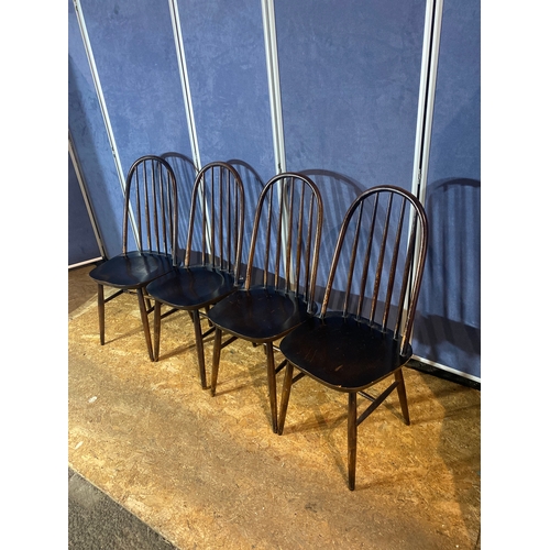 194 - A set of four ebonised stick back chairs