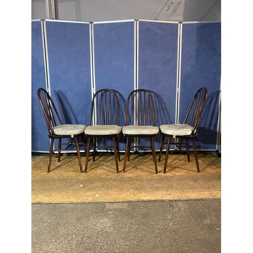 194 - A set of four ebonised stick back chairs