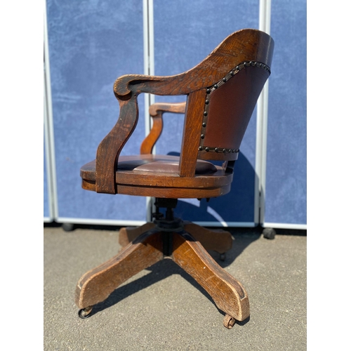 284 - Antique oak and leather swivel desk office chair.