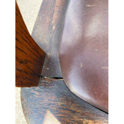 284 - Antique oak and leather swivel desk office chair.