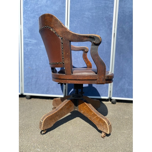 284 - Antique oak and leather swivel desk office chair.