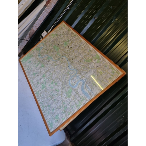 317 - A large framed map of surrounding London area.