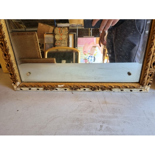 370 - A pair of narrow gilt frames mirrors.