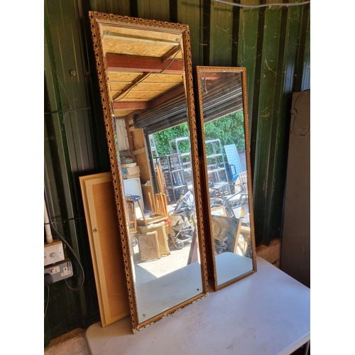 370 - A pair of narrow gilt frames mirrors.