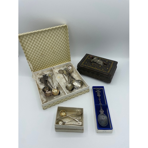 63 - Quantity of plated decorative tea spoons + sterling silver condiment spoons + Eastern box