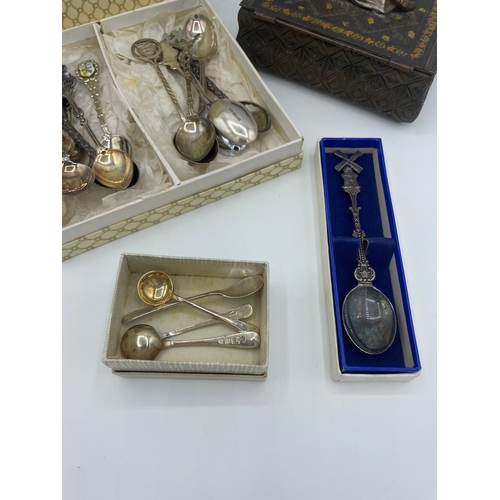 63 - Quantity of plated decorative tea spoons + sterling silver condiment spoons + Eastern box