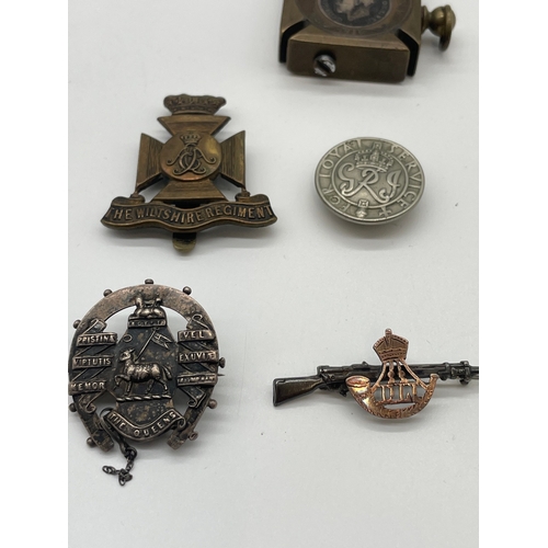 73 - Lot of Four Period Military Cap Badges + trench art lighter from same period 
The Wiltshire Regiment... 