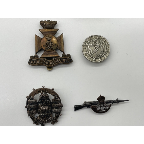 73 - Lot of Four Period Military Cap Badges + trench art lighter from same period 
The Wiltshire Regiment... 