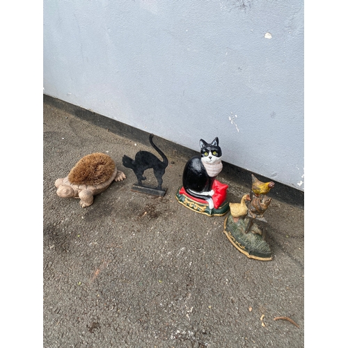 316 - A selection of door stoppers and a shoe brush.