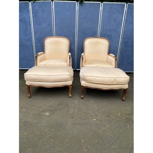 A pair of beautiful regency style arm chairs with ivory upholstery with matching foot stools. 

Please see images for all dimensions.